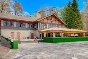 a large house with a green exterior at Downhill Delight in Lake Harmony