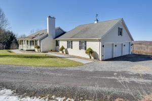 a white house with a driveway at Massive and Modern Coudersport Getaway on 23 Acres! in Coudersport