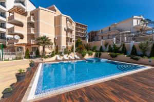 an apartment with a swimming pool in front of a building at Villa Orpheus in Bar