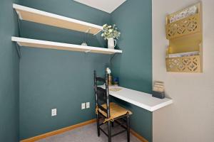 a room with a desk and a wall with a shelf at Charming Home with RV Parking - 30 miles from RMNP! in Loveland
