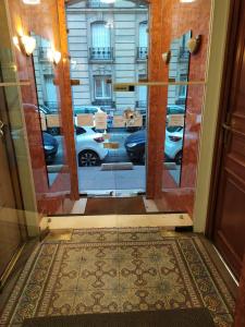 a door with a view of a parking lot at Hôtel Résidence Saint Ouen in Saint-Ouen