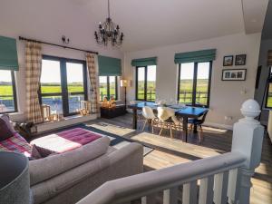 a living room with a couch and a table at 2 Ocean View in Doonbeg