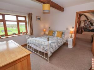a bedroom with a white bed with yellow pillows at Lake View Cottage in Longford