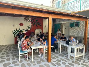 a group of people sitting at tables in a restaurant at Lotus City Sığacık in Seferihisar