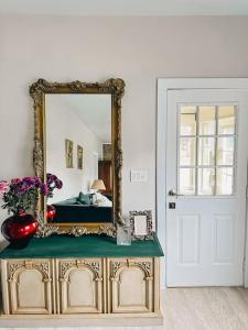 a mirror on top of a dresser in a room at Cozy Private Room in amazing Bungalow in Toronto