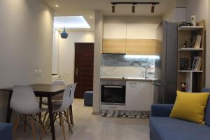a kitchen and dining room with a table and chairs at Sirel Home in Durrës