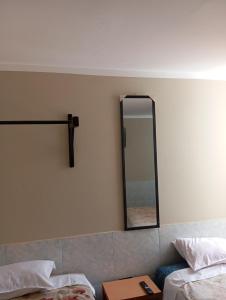 a mirror on the wall of a hotel room at Goya'sHostel in Camaná