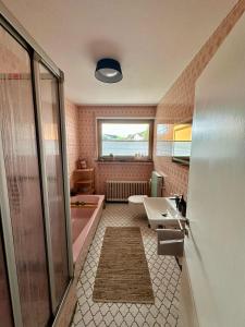 a bathroom with a bath tub and a sink at Eifeeloft - Eifel erleben in Neroth