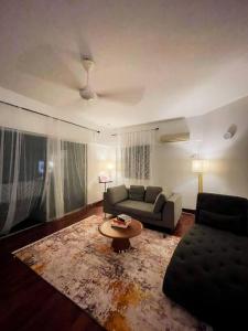 a living room with a couch and a coffee table at Palladium APT / 5mins LRT Damai in Kuala Lumpur