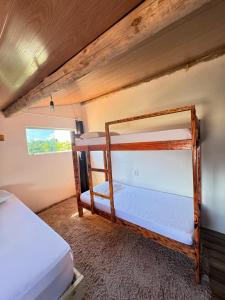 a couple of bunk beds in a room at Hostel Caraivando in Caraíva
