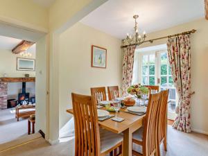 a dining room with a wooden table and chairs at 4 bed in Okehampton 49511 in Sampford Courtenay