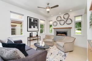 a living room with a couch and chairs and a fireplace at Old Town Oasis - Spacious Artisan Home in Old Town in Fort Collins