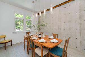 a dining room with a wooden table and chairs at Old Town Oasis - Spacious Artisan Home in Old Town in Fort Collins +36 photos