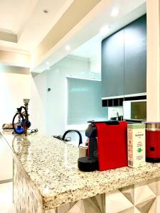 a kitchen with a counter with a red appliance on it at Studio 219 em Santos in Santos +13 photos