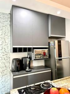 a kitchen with a stove and a refrigerator at Studio 219 em Santos in Santos