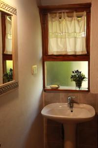 a bathroom with a sink and a window at Cabañas Cerro Amigo in El Bolsón +76 photos