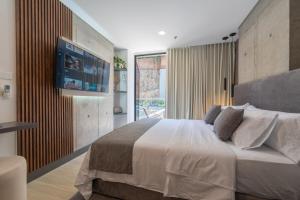 a bedroom with a large bed with a flat screen tv at Riomaggiore City Tower in Cali +283 photos