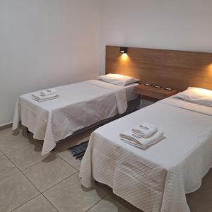 a hotel room with two beds with towels on them at Departamentos por dia EL TREBOL in Paso de los Libres