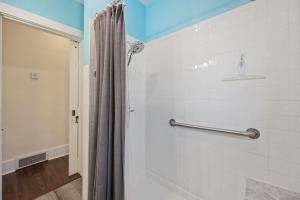 a shower with a shower curtain in a bathroom at Newly Renovated in the Heart of Historic Loveland in Loveland