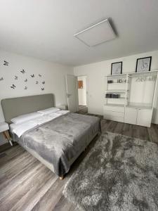 a bedroom with a large bed and a rug at FeWo Style in Balingen