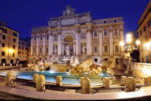 a building with a fountain in front of it at night at La Casa Di Rosa in Rome