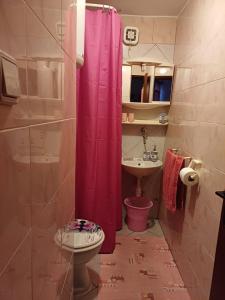 a bathroom with a pink shower curtain and a sink at Apartment in green and quite area, close to beach in Šilo