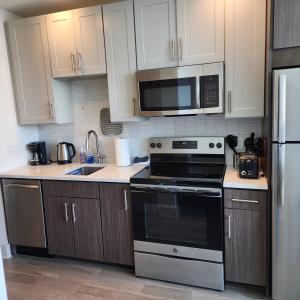 a kitchen with a stove and a microwave at Latitude Med Center in Houston