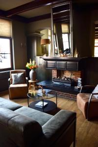 a living room with a couch and a fireplace at Hotel Restaurant 't Ronde Loegh in Winschoten