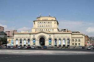 a large white building with cars parked in front of it at Apartment near Republic Square in Yerevan