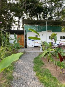 a rv is parked next to a gravel path at Ciudad Rodante La Fortuna , ave 309 in Fortuna