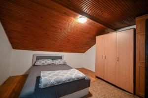 a bedroom with a bed and a wooden ceiling at Villa maskara in Bihać +13 photos