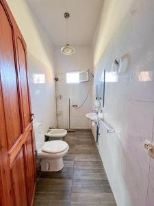 a bathroom with a toilet and a sink at Oceana surf house in Imsouane