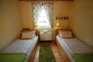 2 camas en una habitación pequeña con ventana en Schönes Ferienhaus in Rothhelmshausen mit Garten, Terrasse und Grill en Fritzlar