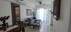 a living room with a couch and a table at Boca del Mar Residence, Boca Chica in Boca Chica