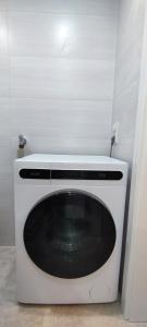 a white washing machine in a corner of a room at Gemütliche Wohnung, Küche, Bad, Netflix, Rheinblick in Kaub