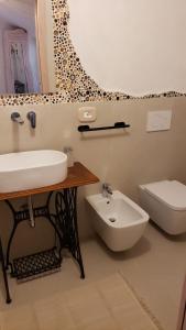 a bathroom with a sink and a toilet at A Burgâ du Muntin in Spotorno