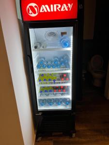 an open refrigerator filled with lots of water and drinks at Casa sabina aeropuerto plus 1 in Lima
