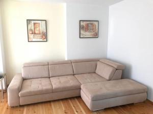 a living room with a couch and two pictures on the wall at Ferienwohnung für 3 Personen in Bad Saarow, Berlin - b43675 in Bad Saarow