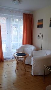 a living room with a couch and a table at Ferienwohnung für 3 Personen in Bad Saarow, Berlin - b43675 in Bad Saarow