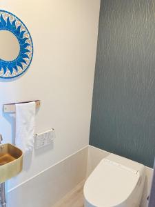 a bathroom with a white toilet and a sink at Condominium Hotel Okinawa Yumeto - Vacation STAY 16578v in Nanjo