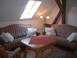 a living room with two couches and a table at Haus Hermann in Presseck