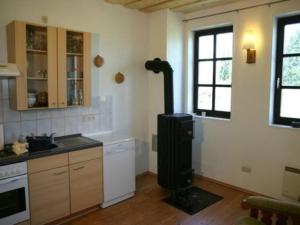 a kitchen with a stove in the corner of a room at Haus Hermann in Presseck