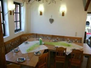 a dining room with a wooden table and chairs at Haus Hermann in Presseck