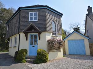 a house with a blue door and a garage at 3 bed property in Bude HAPPY in Poughill