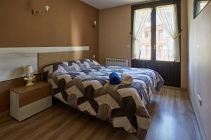 a bedroom with a bed with a stuffed animal on it at Santa Cruz in Broto