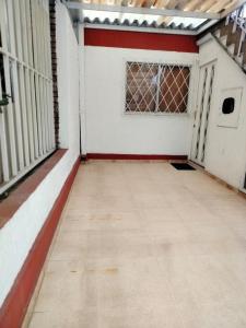 an empty garage with a door and a window at Hermoso departamento mejor ubicación Modelia Bta. in Bogotá