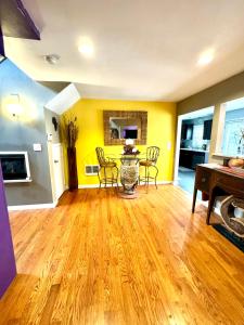 a living room with yellow walls and a table and chairs at Zen Life Oasis in Atlanta