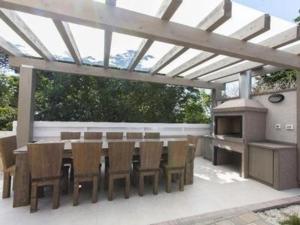 a patio with a table and chairs and a fireplace at Die komfortable und geräumige Villa liegt in einer ruhigen Gegend, im Touristikstädtchen Premantura, in Pula