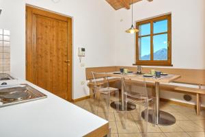 a kitchen with a table and chairs and a window at A Casa di Anna Maria in Brenzone sul Garda +17 photos