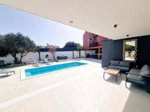 an outdoor patio with a swimming pool and furniture at Villa Lumino in Murter +12 photos